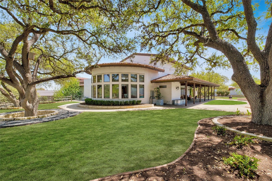 9770 Farm To Market 967 Buda, TX 78610 - Photo 34 of 40 a front view of a house with a garden