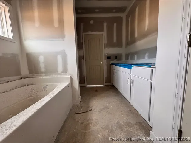 a kitchen with cabinets and window