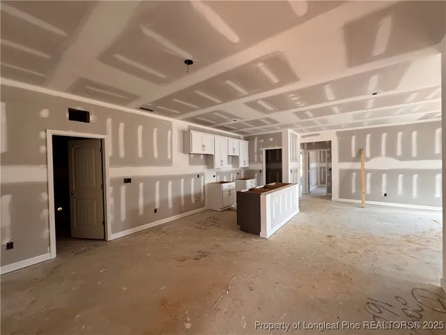 a large white kitchen with a large window