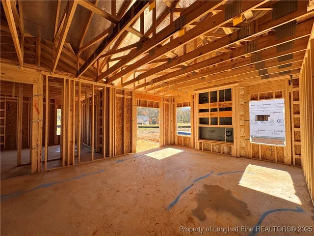 a view of an empty room with closet and window