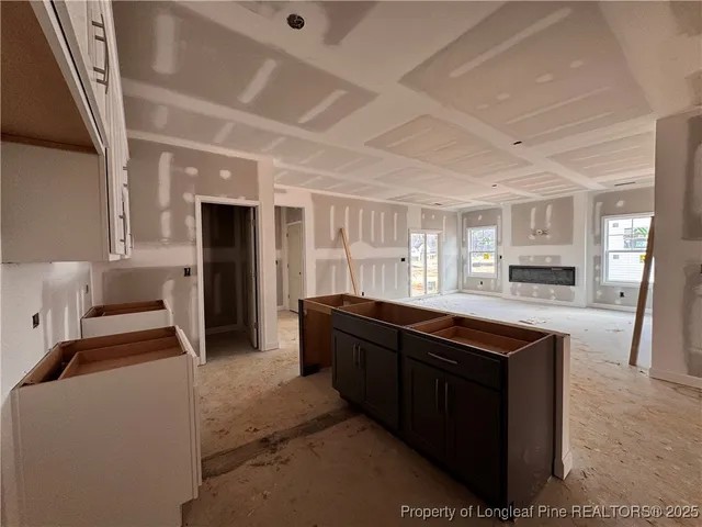 a kitchen with stainless steel appliances granite countertop a sink and a refrigerator