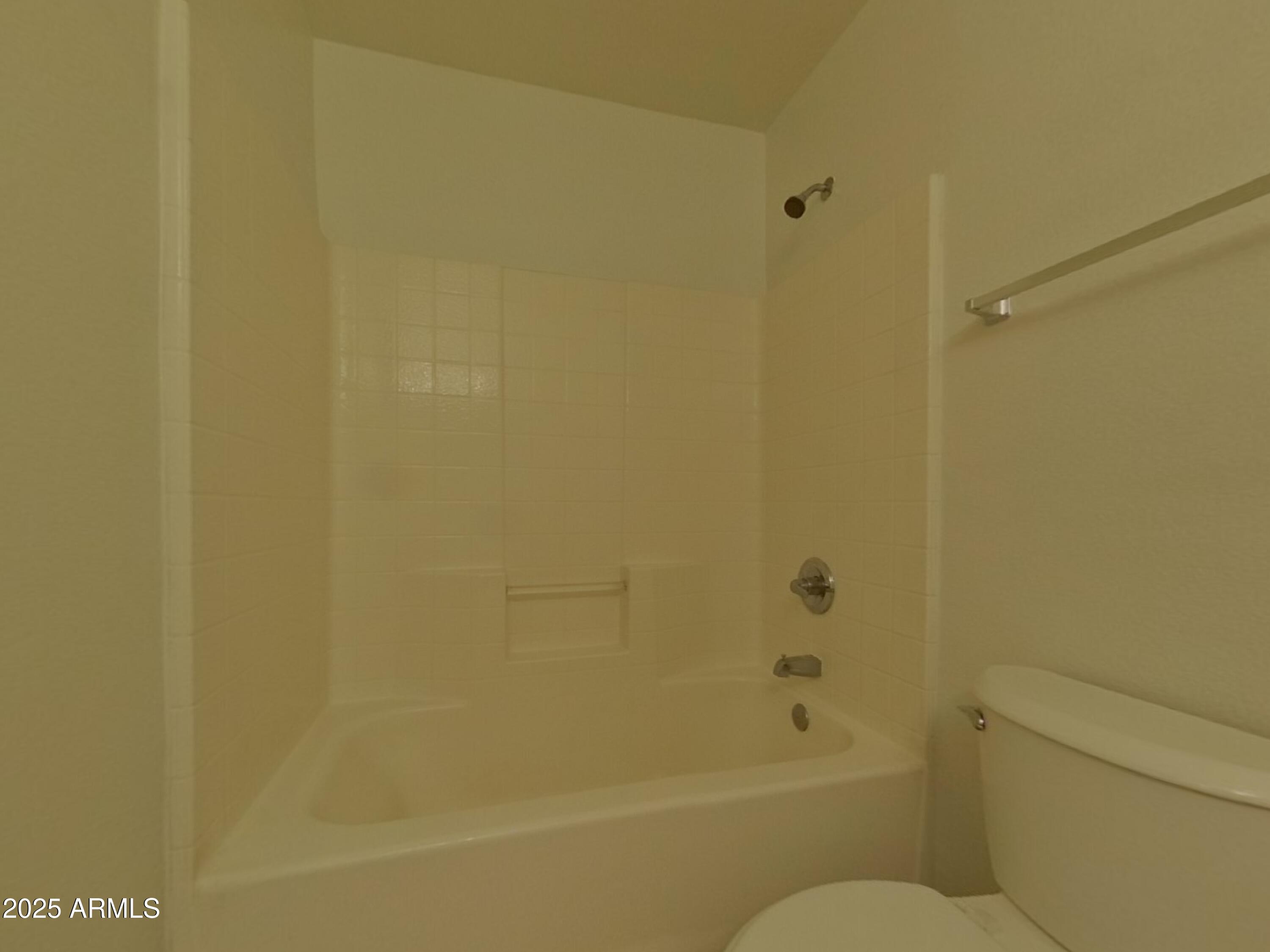 10365 West Piccadilly Road Avondale, AZ 85392 - Photo 16 of 20 a bathroom with a granite countertop toilet and a bathtub