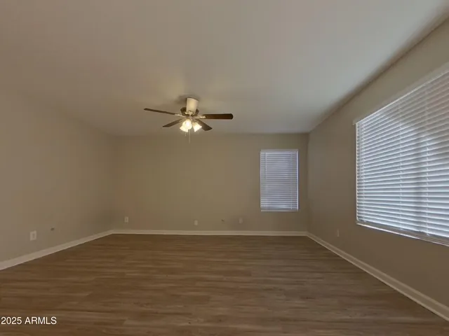 a view of a room with wooden floor and window