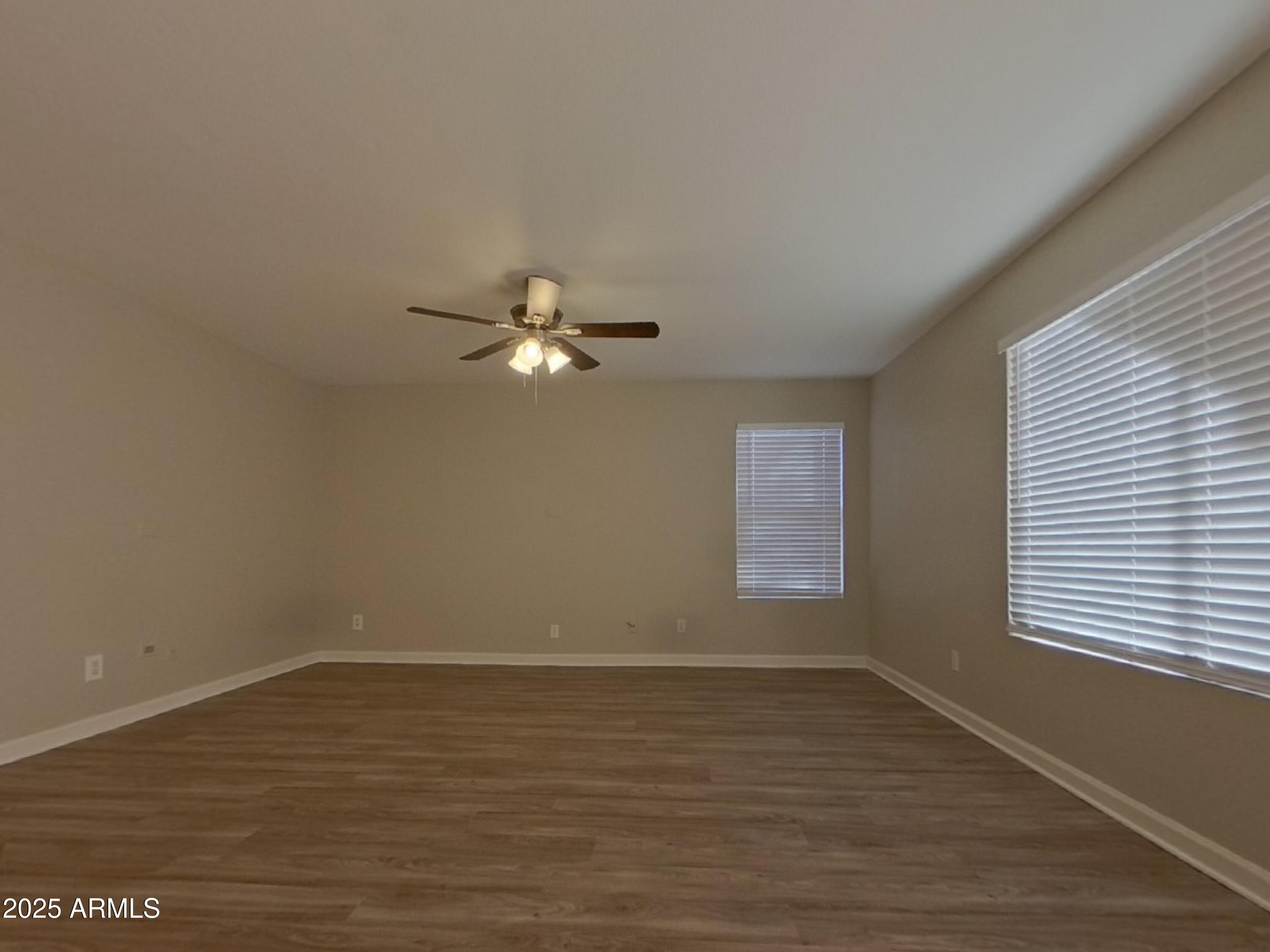 10365 West Piccadilly Road Avondale, AZ 85392 - Photo 18 of 20 a view of a room with wooden floor and window