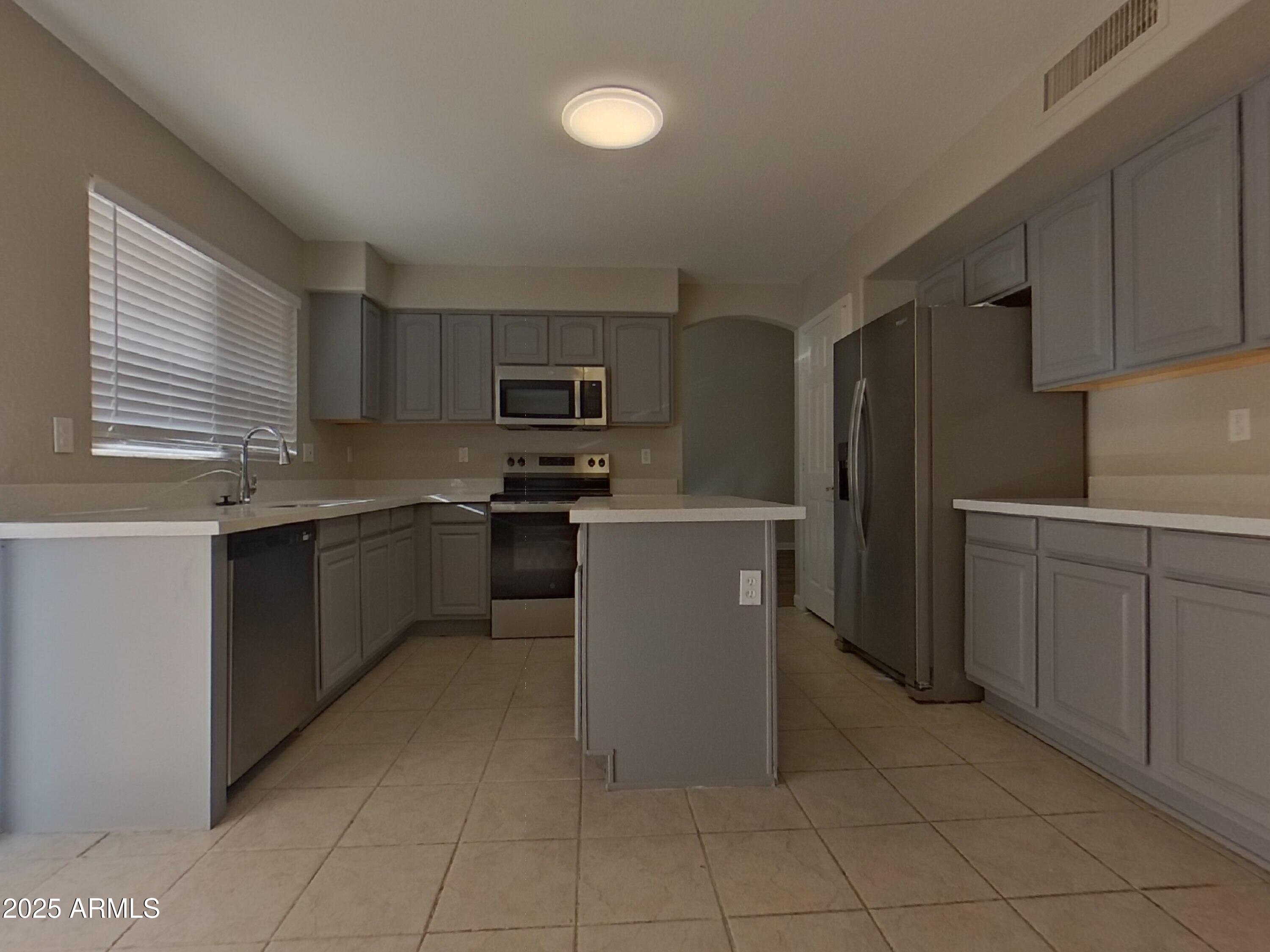 10365 West Piccadilly Road Avondale, AZ 85392 - Photo 5 of 20 a kitchen with cabinets and a stainless steel appliances