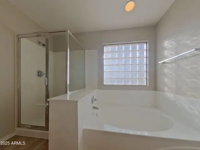 a bathroom with a bathtub and a shower