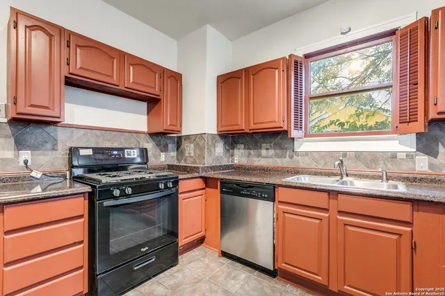 a kitchen with stainless steel appliances granite countertop wooden cabinets stove top oven and sink