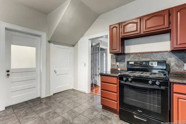 a kitchen with stainless steel appliances granite countertop a stove and a microwave