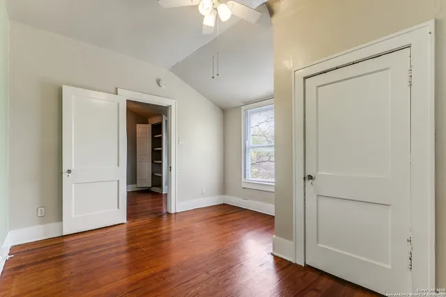 an empty room with wooden floor and a window