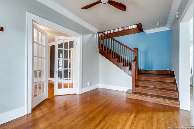 a view of entryway and hall with wooden floor