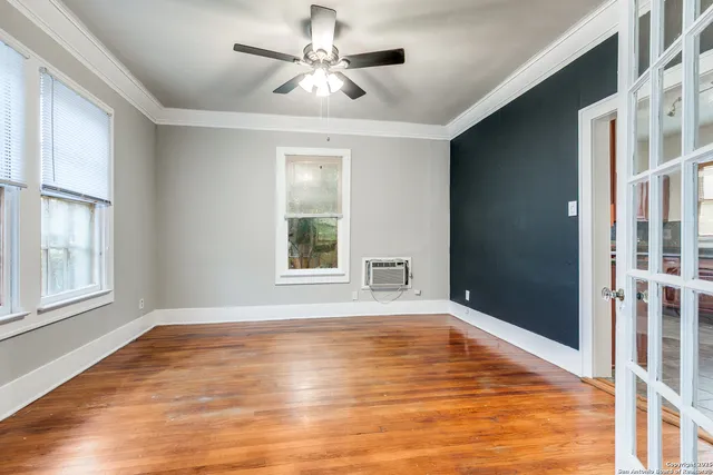 wooden floor in an empty room with a window