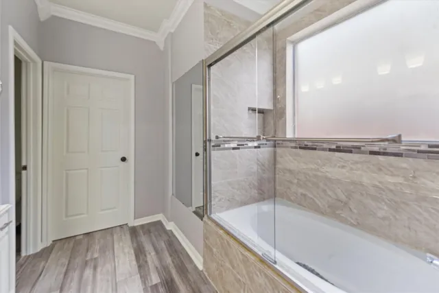 a bathroom with a bathtub and a shower