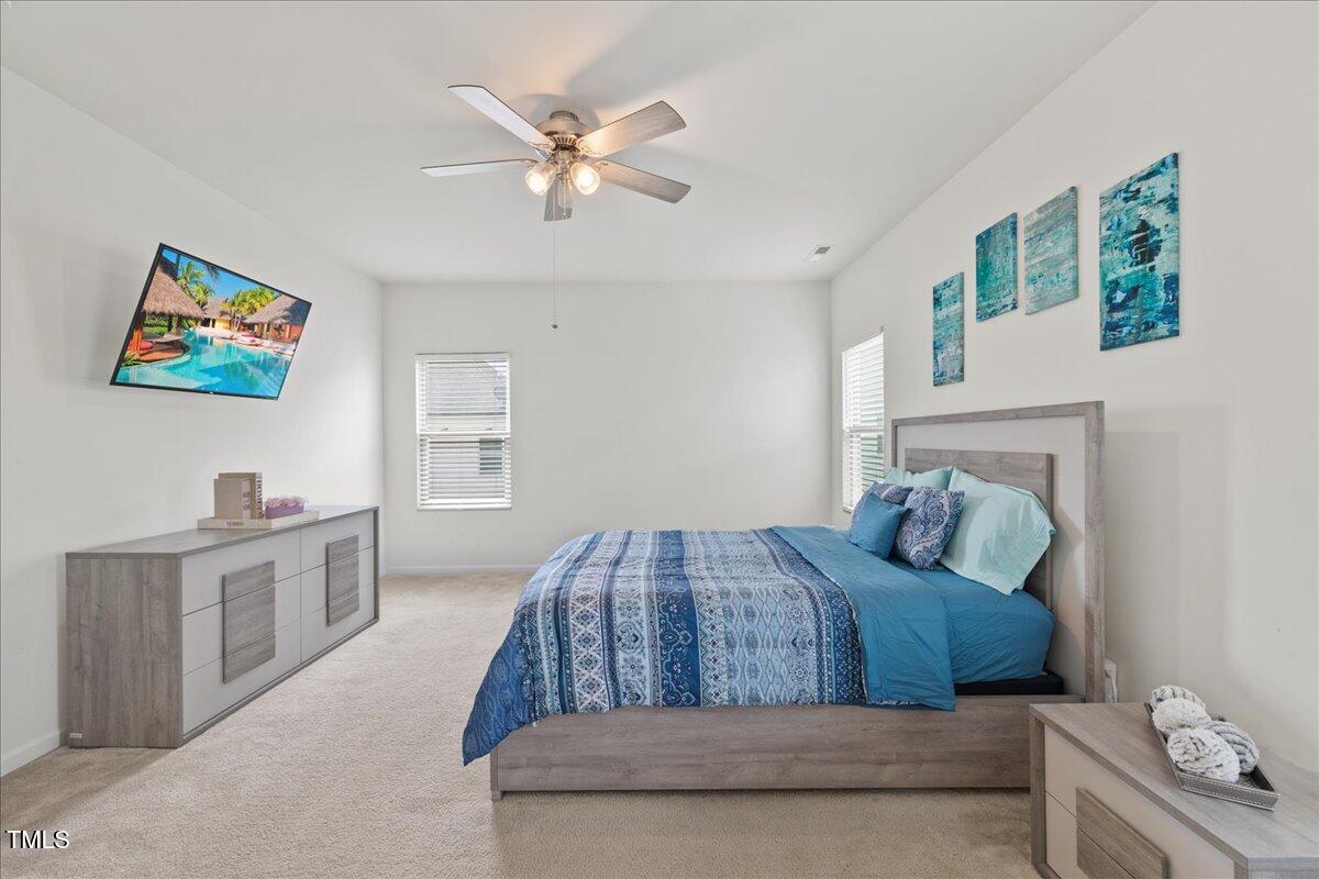 1610 Stone Road Durham, NC 27703 - Photo 13 of 40 a bedroom with a bed and a chandelier