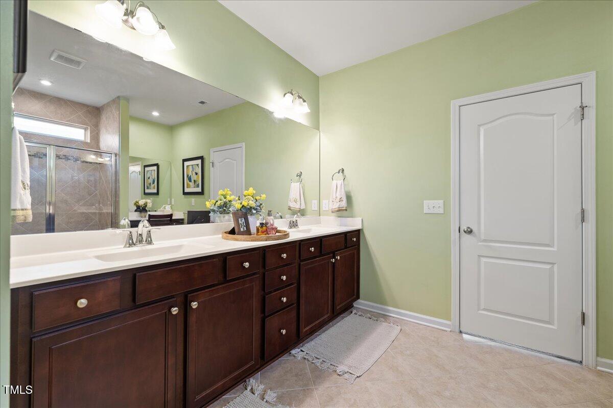 1610 Stone Road Durham, NC 27703 - Photo 15 of 40 a bathroom with a sink and a mirror