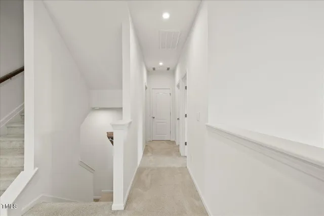 a view of a bathroom with white walls