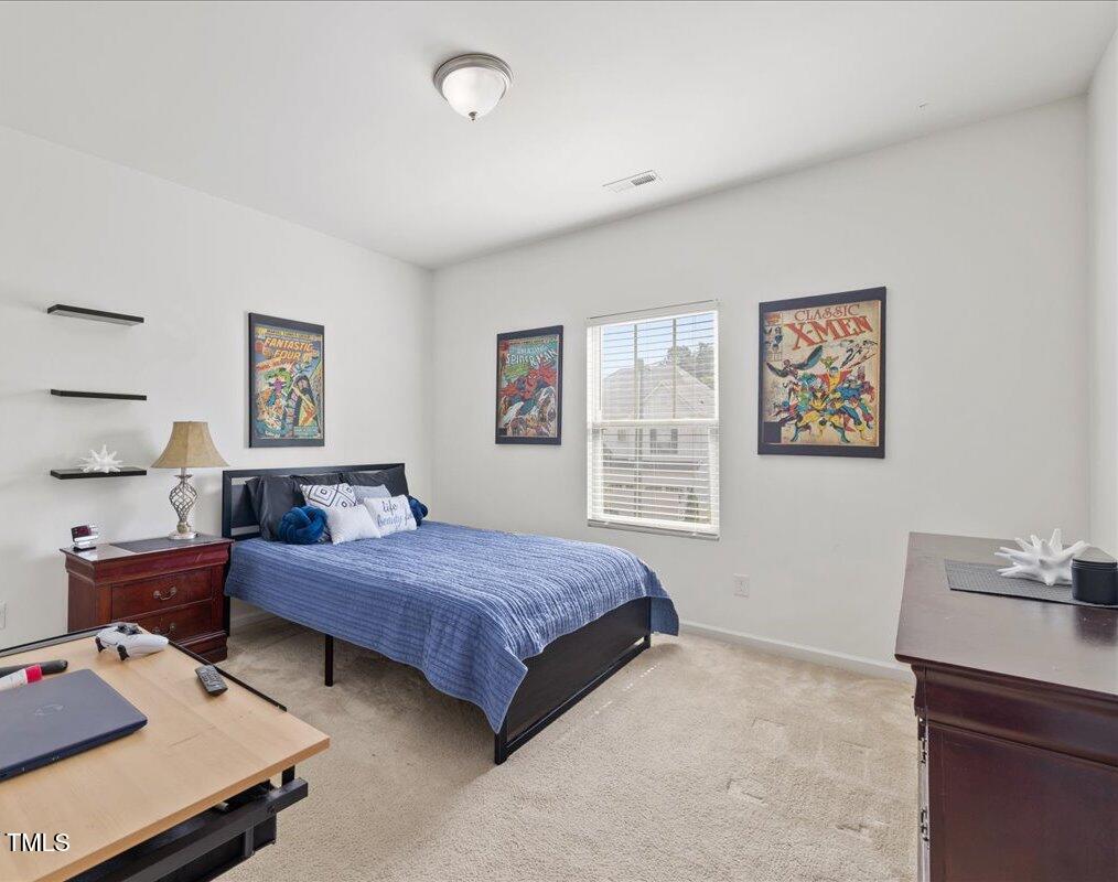 1610 Stone Road Durham, NC 27703 - Photo 18 of 40 a bedroom with a bed and wooden furniture