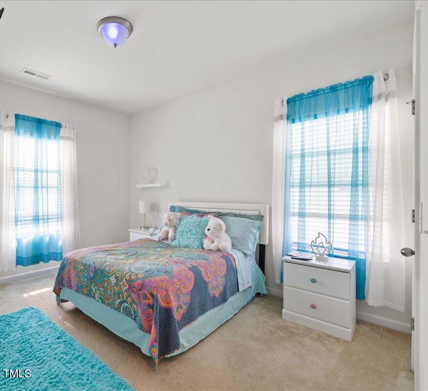 1610 Stone Road Durham, NC 27703 - Photo 19 of 40 a bedroom with a bed and a window