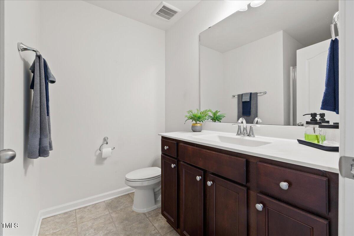 1610 Stone Road Durham, NC 27703 - Photo 23 of 40 a bathroom with a sink and a mirror