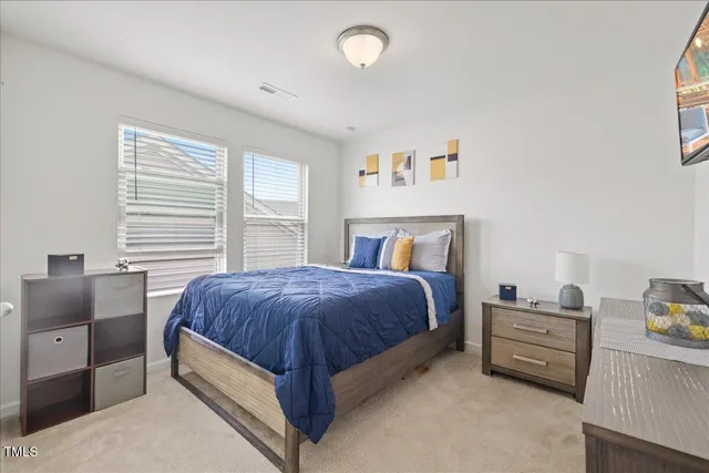 a bed room with a bed and a chair