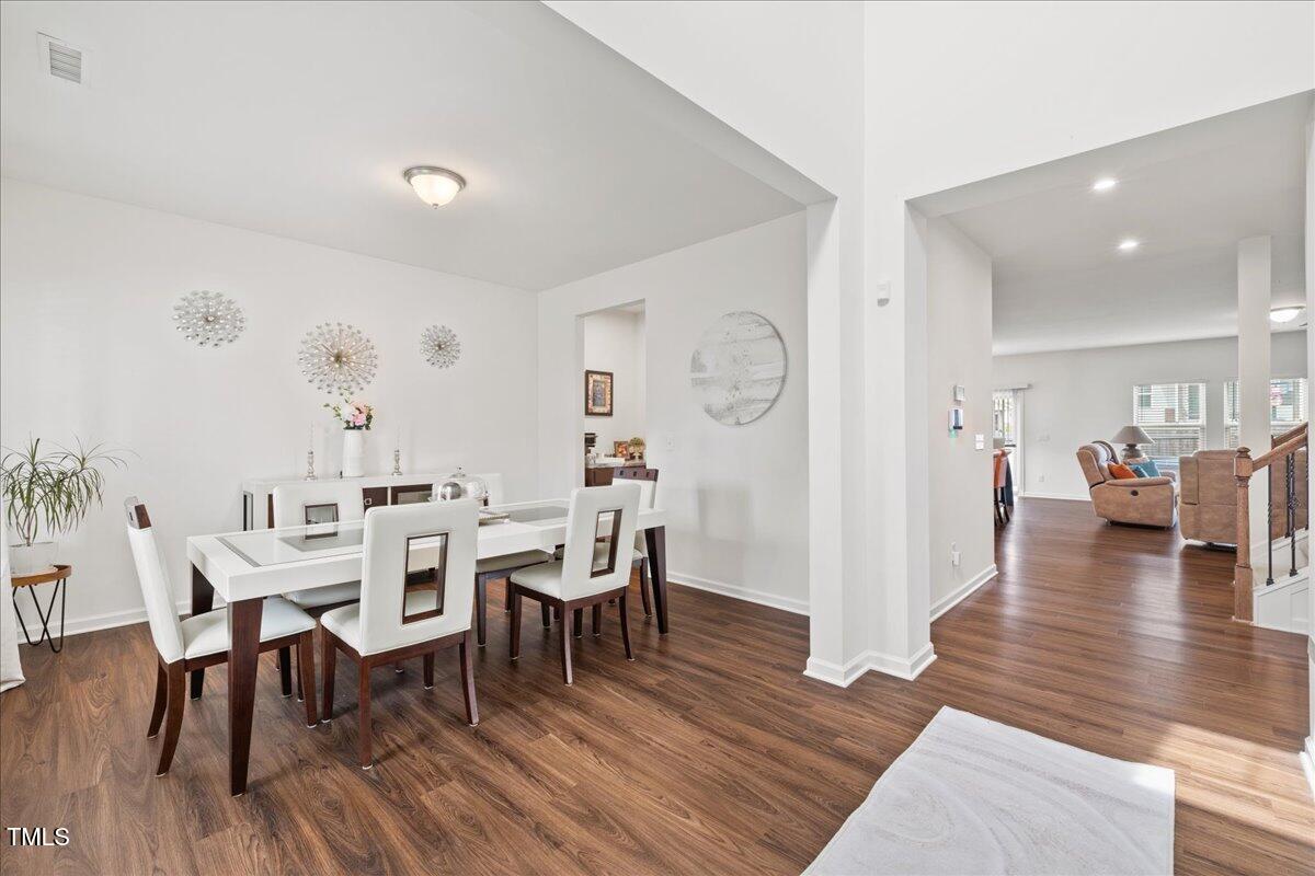 1610 Stone Road Durham, NC 27703 - Photo 3 of 40 a view of a dining room with furniture and wooden floor