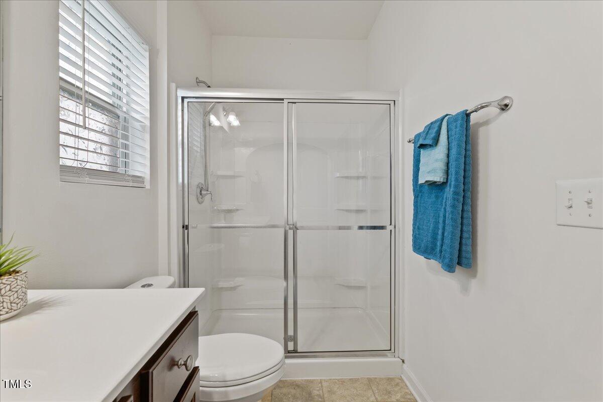 1610 Stone Road Durham, NC 27703 - Photo 8 of 40 a bathroom with a sink a toilet and shower