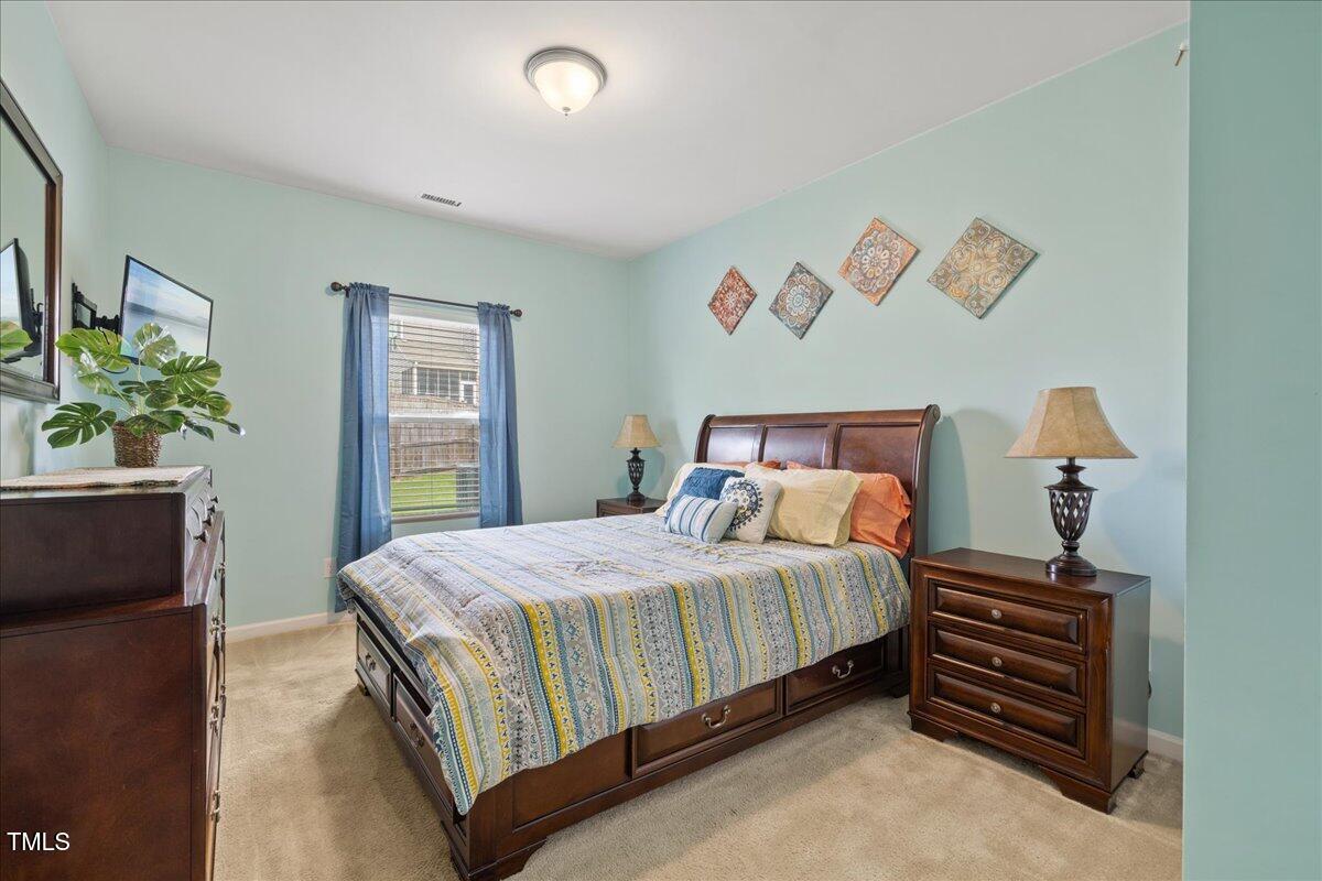 1610 Stone Road Durham, NC 27703 - Photo 9 of 40 a bedroom with a bed and a potted plant