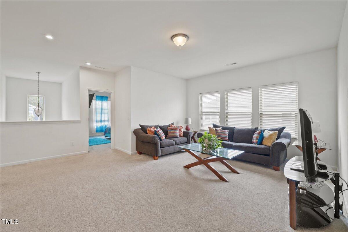 1610 Stone Road Durham, NC 27703 - Photo 10 of 40 a living room with furniture and a flat screen tv