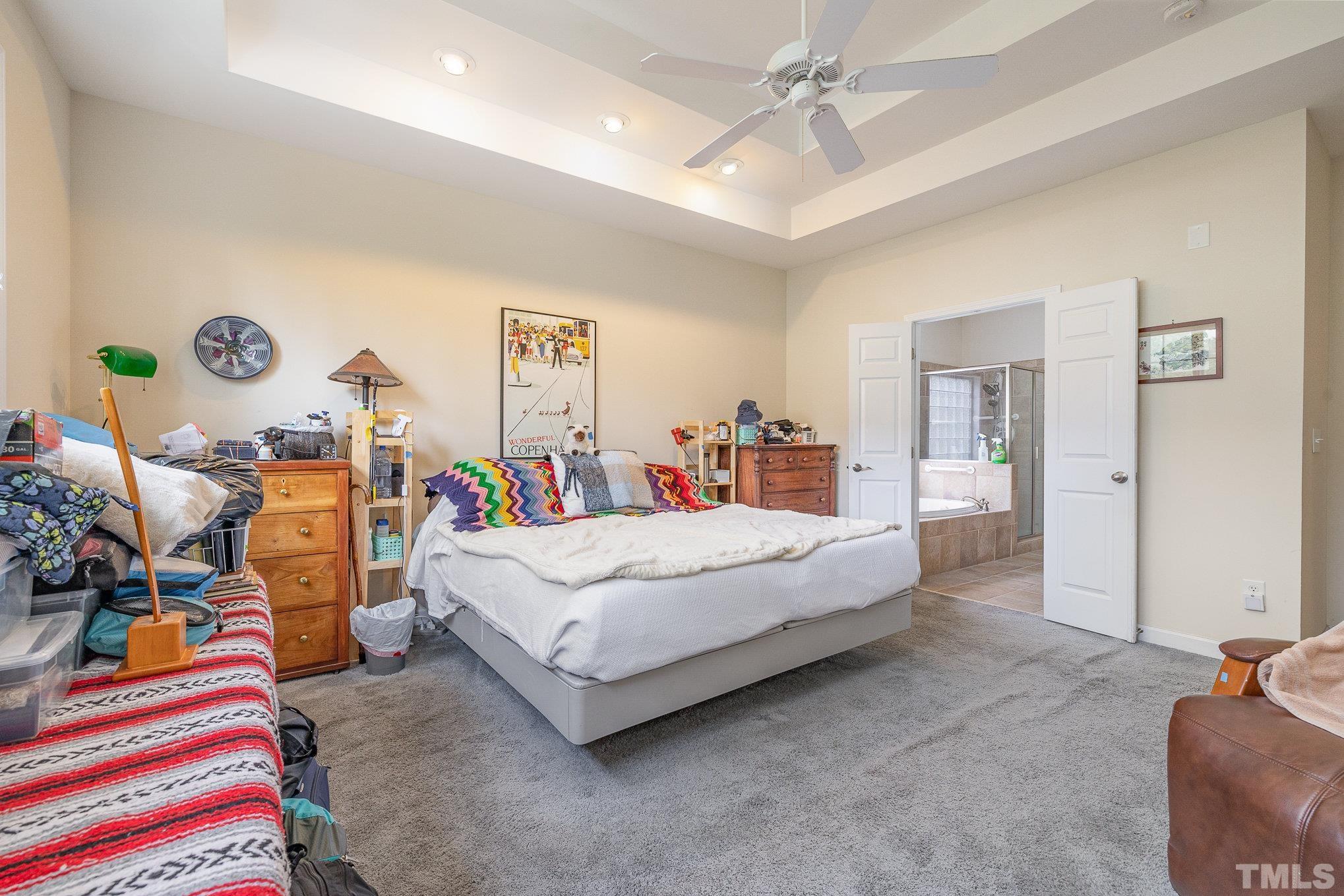 306 Few Circle Durham, NC 27705 - Photo 14 of 28 a spacious bedroom with a bed and a chandelier