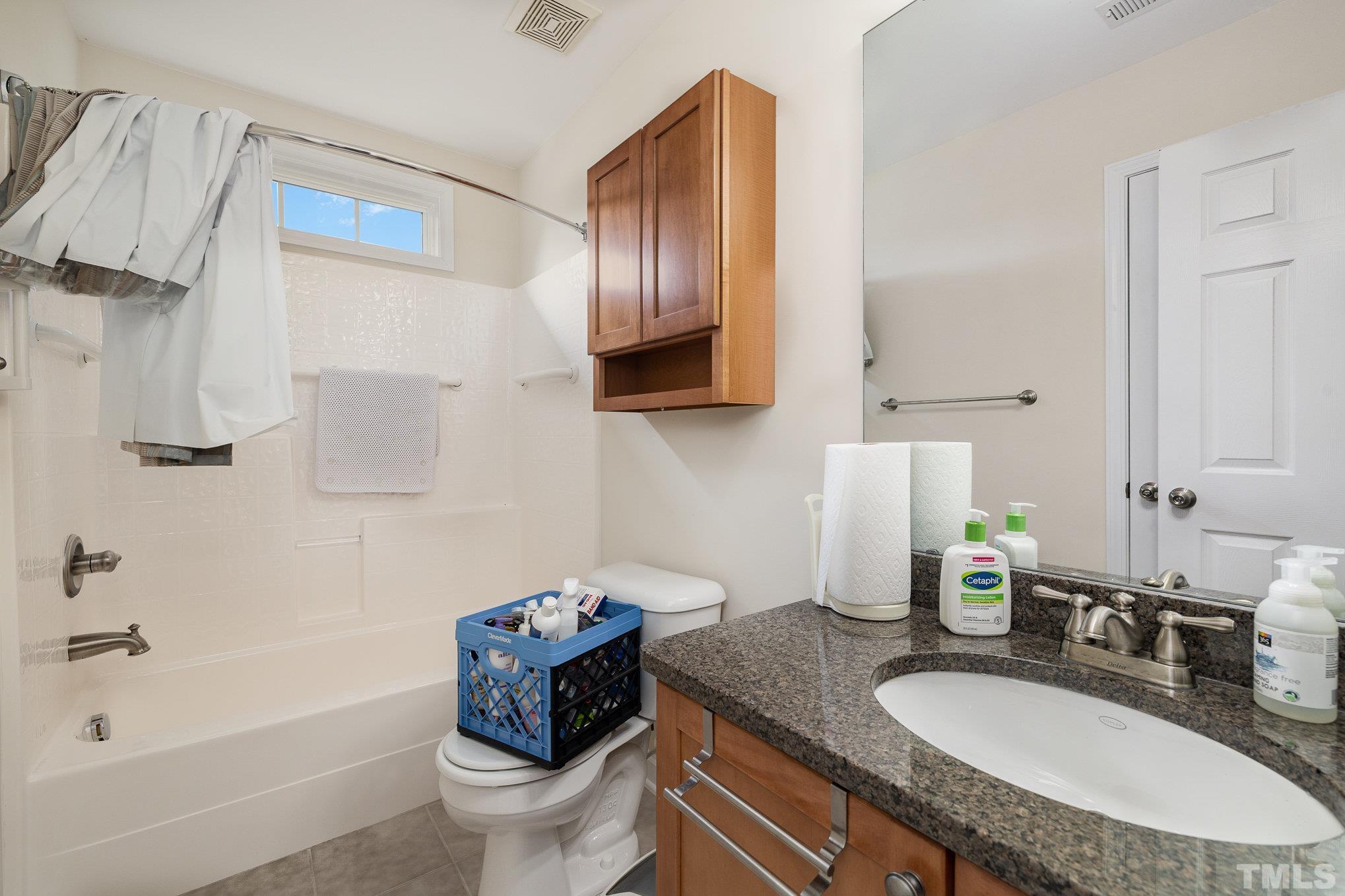 306 Few Circle Durham, NC 27705 - Photo 17 of 28 a bathroom with a granite countertop sink a toilet and a bathtub