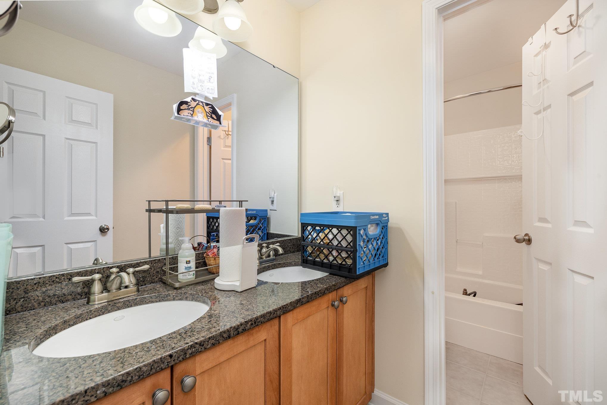 306 Few Circle Durham, NC 27705 - Photo 22 of 28 a bathroom with a granite countertop sink and a mirror