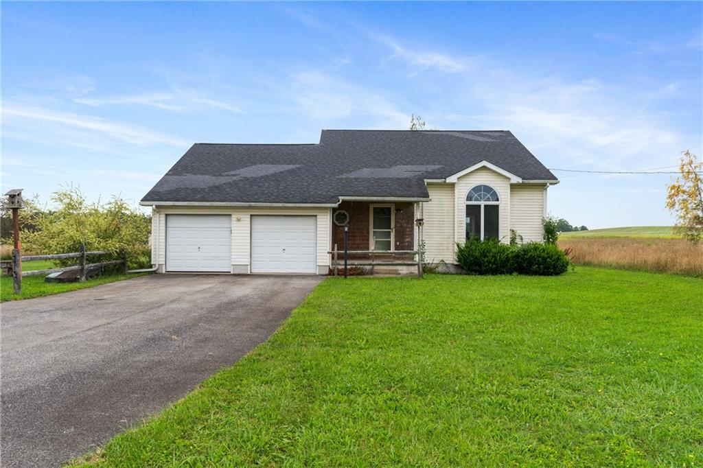 3298 Miola Road Clarion, PA 16214 - Photo 1 of 38 a front view of a house with a yard and garage