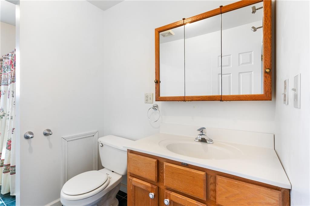 3298 Miola Road Clarion, PA 16214 - Photo 15 of 38 a bathroom with a sink a toilet and a mirror