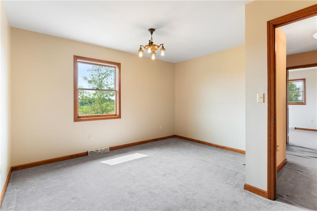 3298 Miola Road Clarion, PA 16214 - Photo 23 of 38 an empty room with windows and chandelier fan