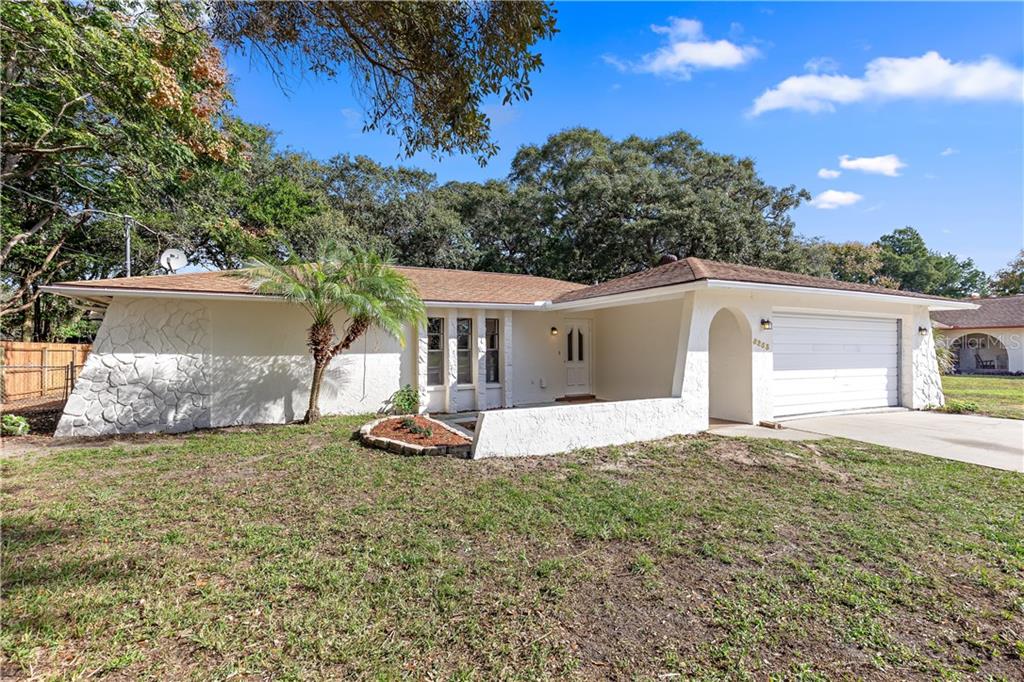 8253 Annapolis Road Spring Hill, FL 34606 - Photo 1 of 1 a front view of a house with a yard and garage