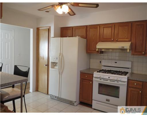 1 Barlow Road Edison, NJ 08817 - Photo 2 of 17 a kitchen with stainless steel appliances a stove a refrigerator and cabinets