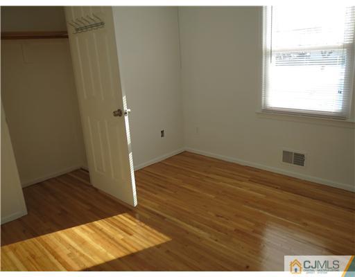 1 Barlow Road Edison, NJ 08817 - Photo 11 of 17 an empty room with wooden floor and windows