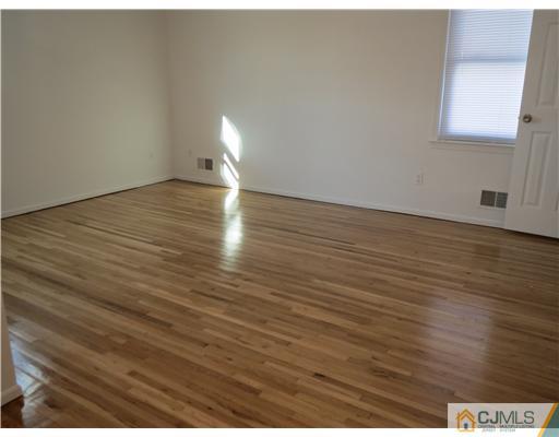 1 Barlow Road Edison, NJ 08817 - Photo 7 of 17 a view of an empty room with wooden floor