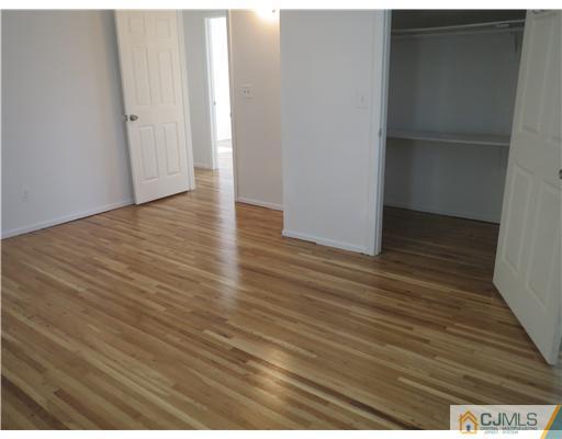 1 Barlow Road Edison, NJ 08817 - Photo 8 of 17 a view of an empty room with wooden floor