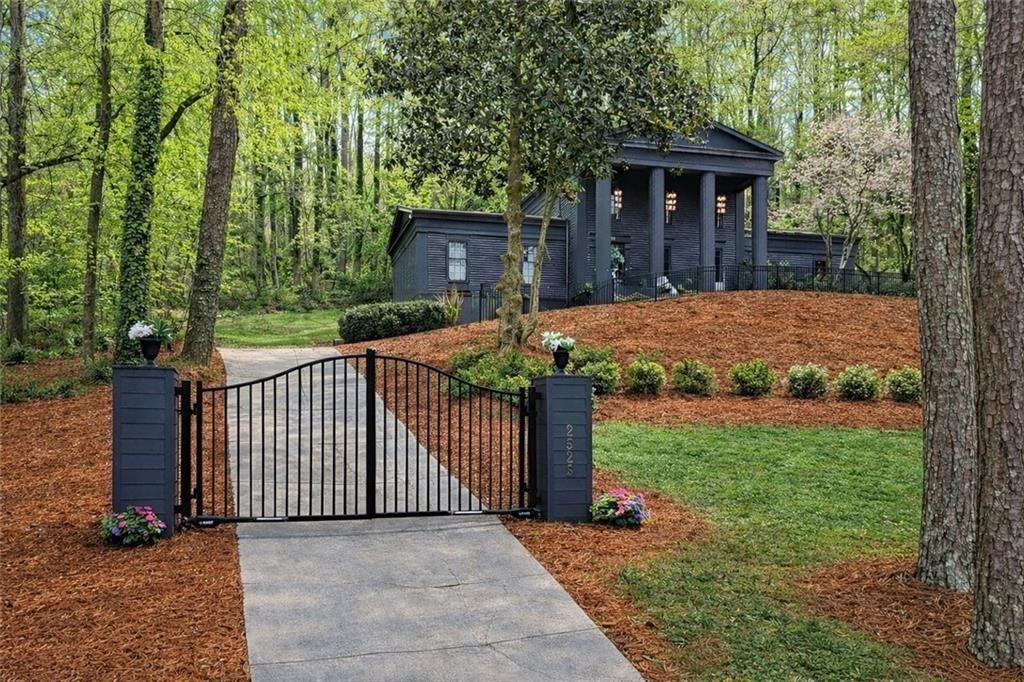 2525 Spalding Drive Atlanta, GA 30350 - Photo 1 of 58 a view of a brick house with a yard and large tree
