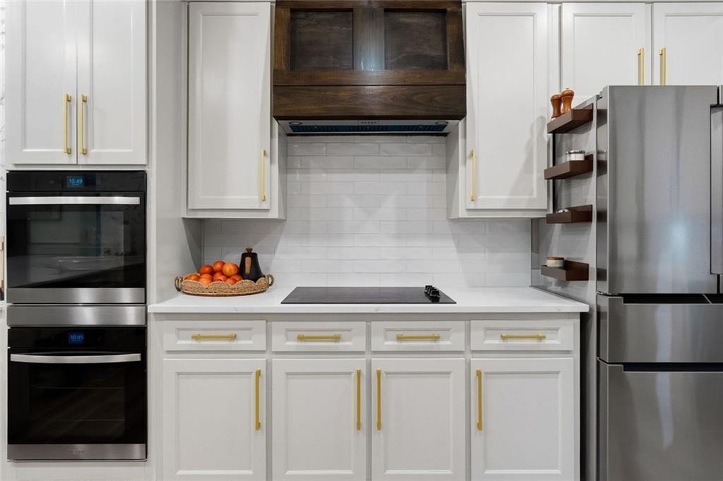 2525 Spalding Drive Atlanta, GA 30350 - Photo 18 of 58 a kitchen with stainless steel appliances and white cabinets
