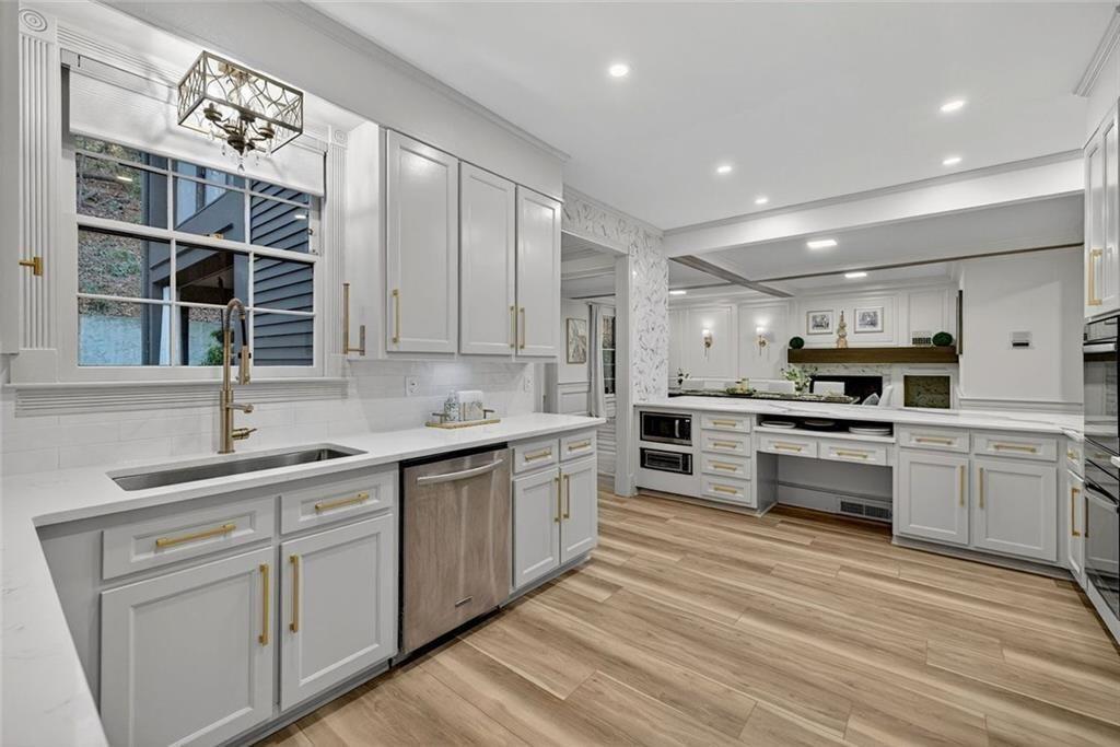 2525 Spalding Drive Atlanta, GA 30350 - Photo 23 of 58 a kitchen with a sink white cabinets and white appliances