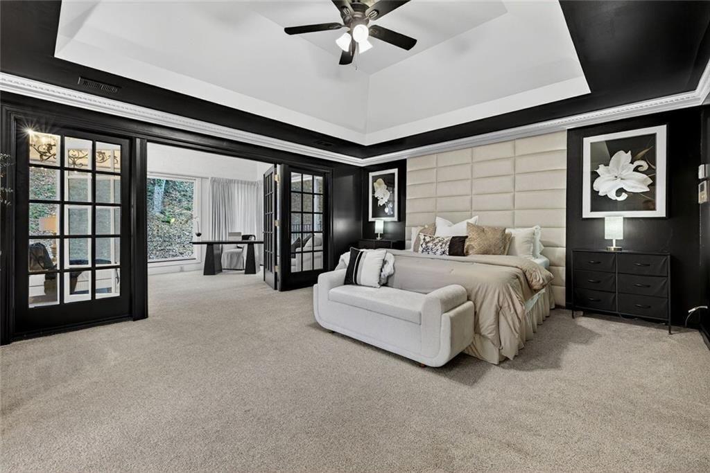 2525 Spalding Drive Atlanta, GA 30350 - Photo 28 of 58 a spacious bedroom with a balcony a bed and a large window