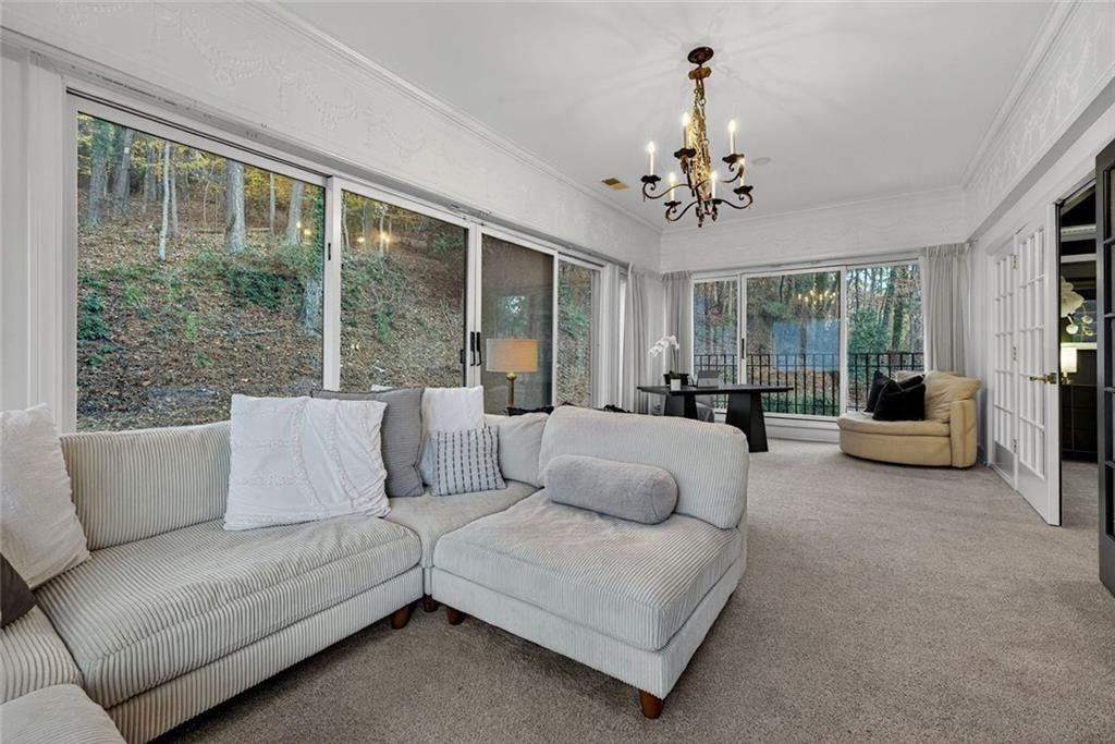 2525 Spalding Drive Atlanta, GA 30350 - Photo 31 of 58 a living room with furniture and a chandelier