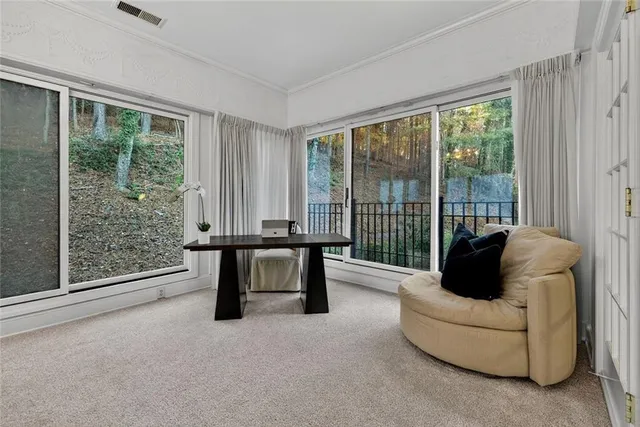 a living room with furniture a clock and a flat screen tv