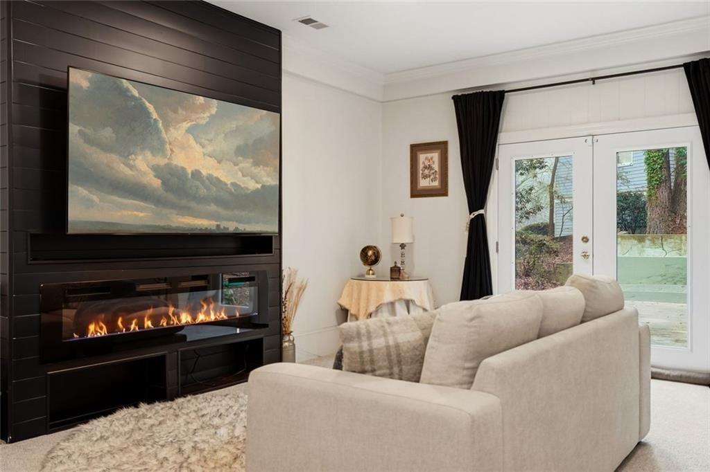 2525 Spalding Drive Atlanta, GA 30350 - Photo 52 of 58 a living room with furniture a flat screen tv and a floor to ceiling window