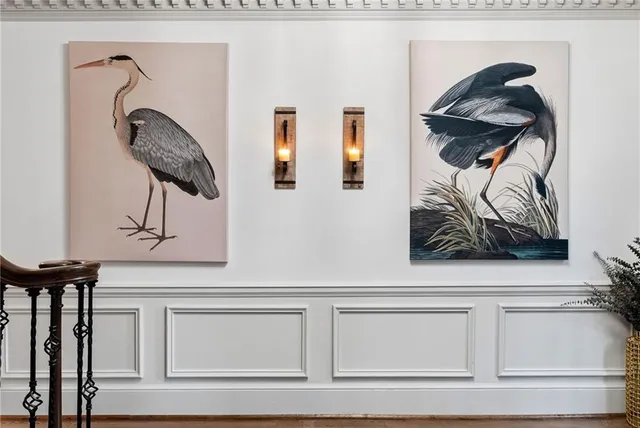 a living room with a fireplace and potted plant