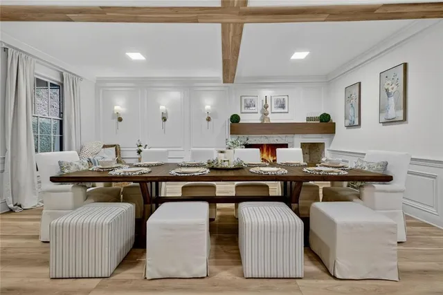 a kitchen with granite countertop a table chairs sink and cabinets
