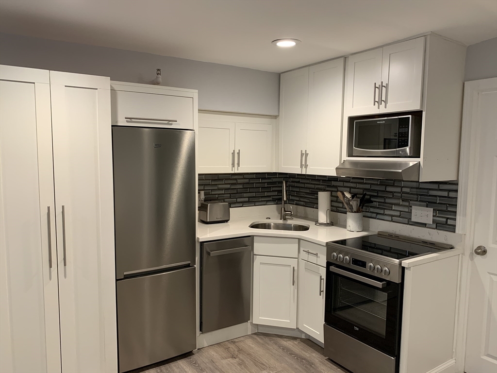 122 Beacon Street, Unit 1 Boston, MA 02116 - Photo 2 of 5 a kitchen with a refrigerator stove and microwave