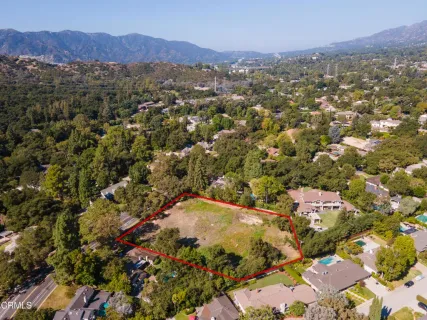 an aerial view of residential house and sandy dunes