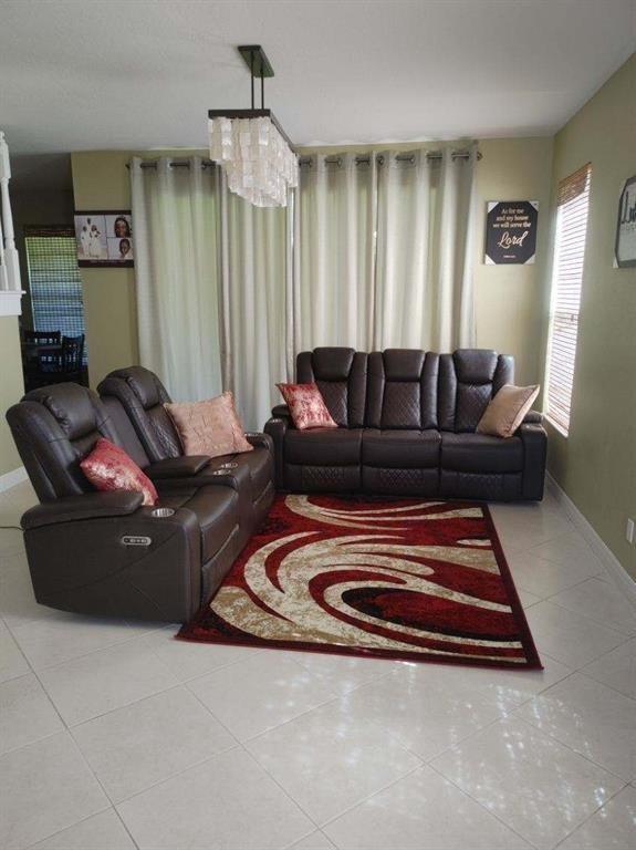 2009 Grey Falcon Circle Southwest Vero Beach, FL 32962 - Photo 4 of 9 a living room with furniture rug and a window